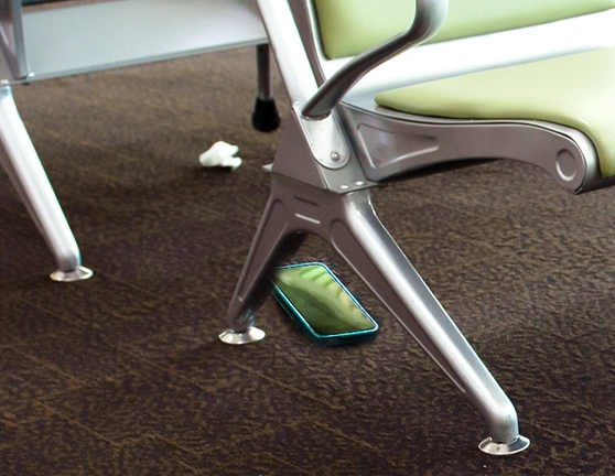 Smartphone caído en el suelo con asientos vacíos